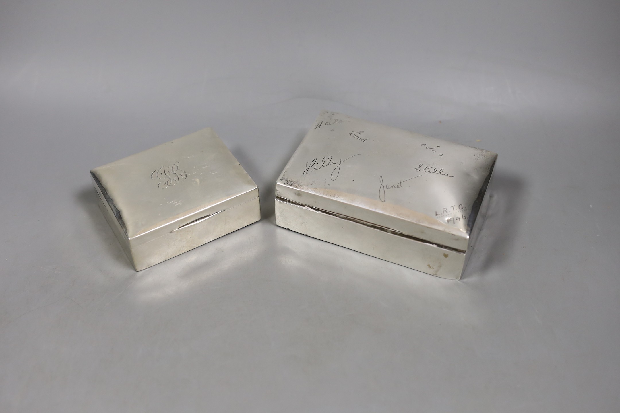 A George V silver mounted cigarette box, William Hutton & Sons, Birmingham, 1917, 89mm and a later larger Egyptian white metal cigarette box.